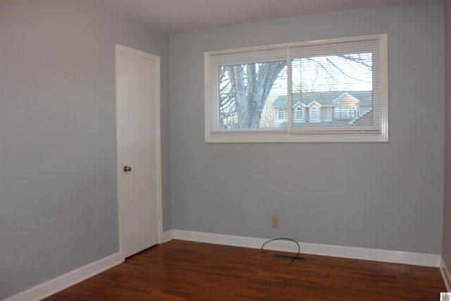 spare room with dark wood-type flooring