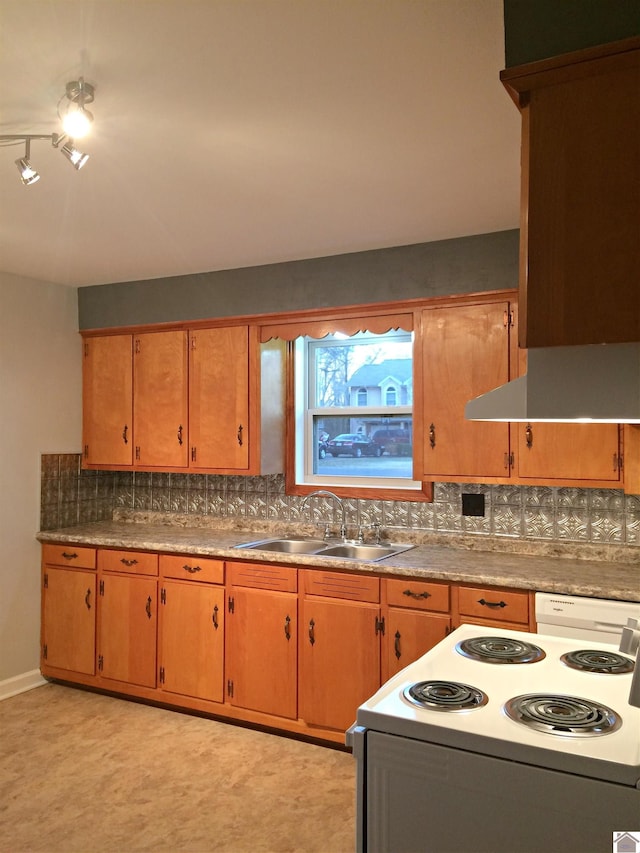 kitchen featuring sink, backsplash, and electric stove