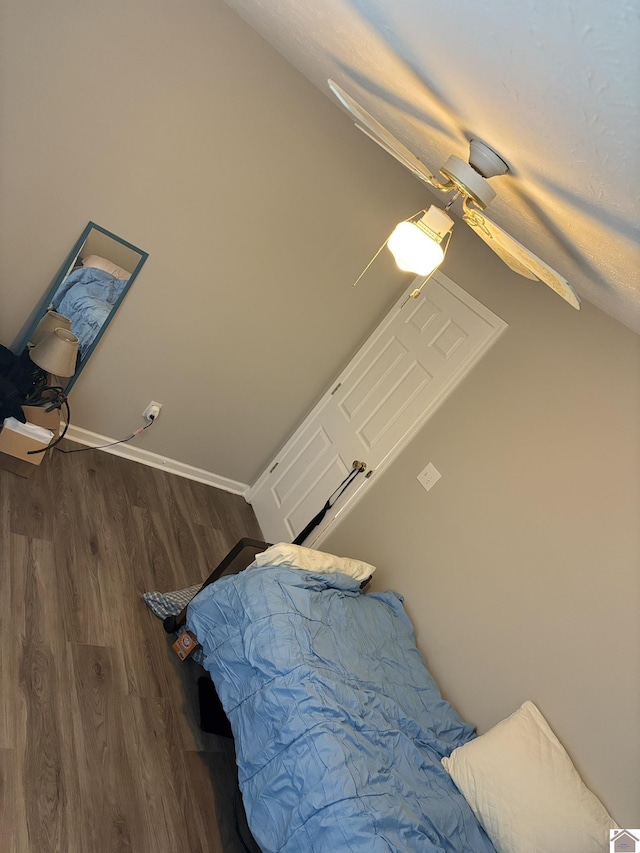 bedroom with dark wood-type flooring and vaulted ceiling