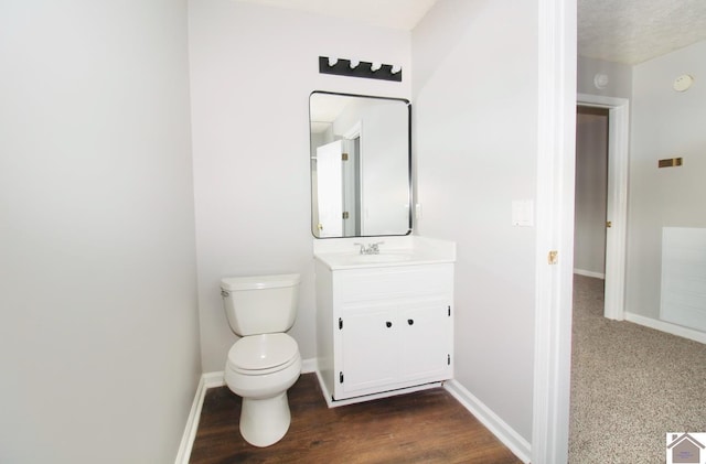 bathroom featuring hardwood / wood-style flooring, vanity, and toilet