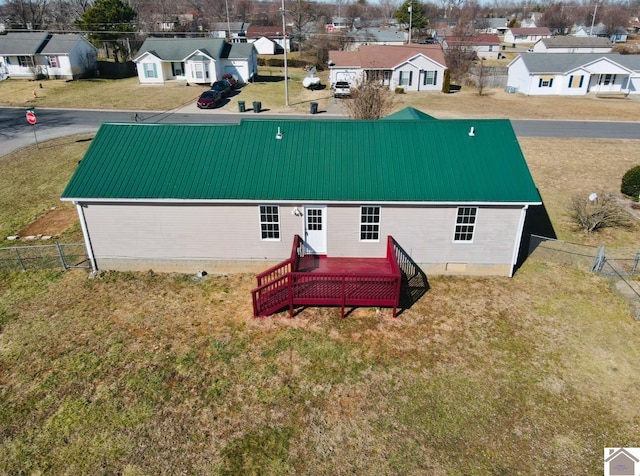 back of house featuring a deck and a lawn