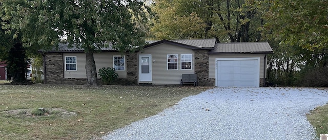 ranch-style home with a garage and a front lawn