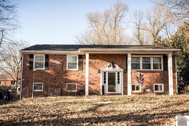 split foyer home featuring brick siding