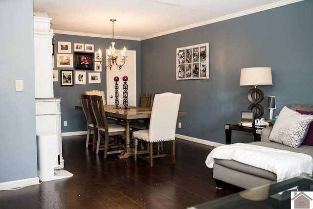 dining area with ornamental molding, a notable chandelier, baseboards, and wood finished floors