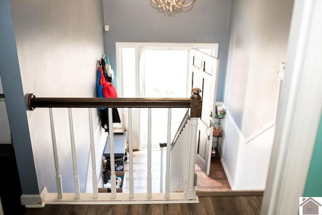 staircase featuring baseboards and wood finished floors