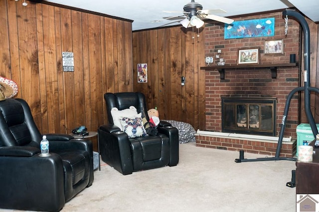 carpeted living room with ceiling fan, a brick fireplace, and wooden walls