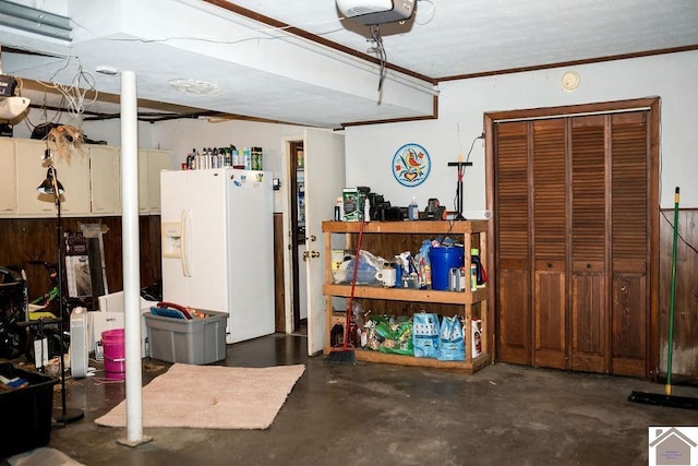 interior space featuring white fridge with ice dispenser and a garage door opener