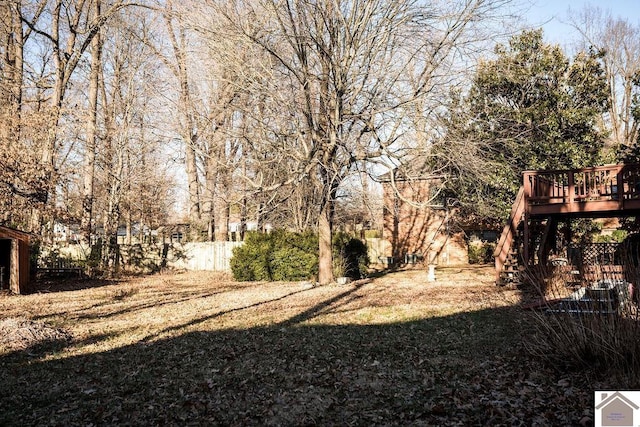 view of yard featuring stairs, fence, and a deck