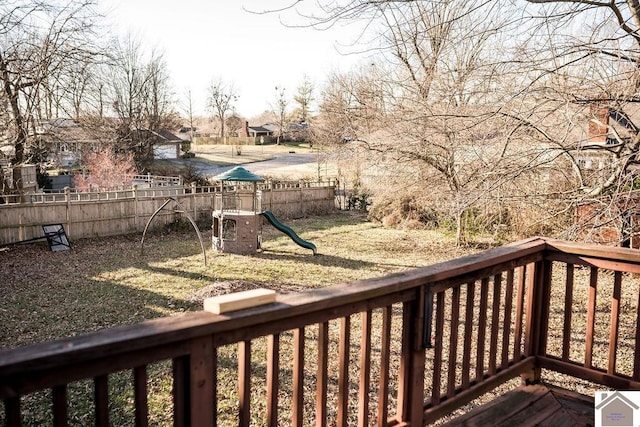 wooden terrace featuring a playground and fence