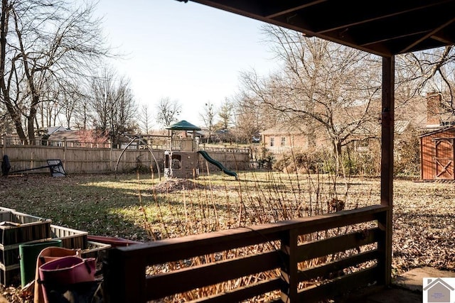 view of yard featuring a playground and fence