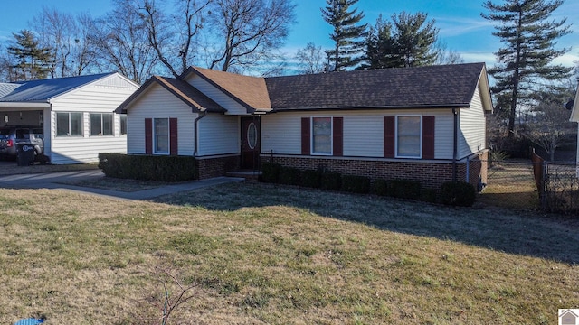 ranch-style home with a carport and a front lawn