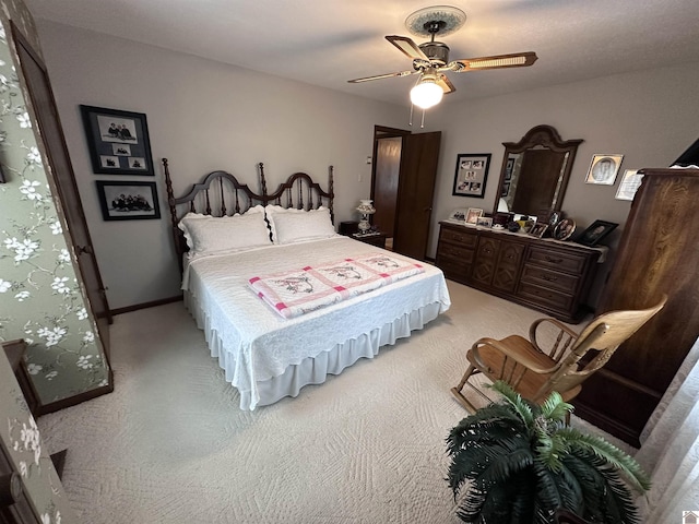 bedroom with ceiling fan and light colored carpet