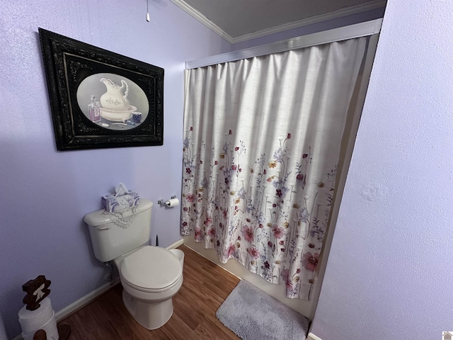 bathroom featuring hardwood / wood-style floors, crown molding, and toilet