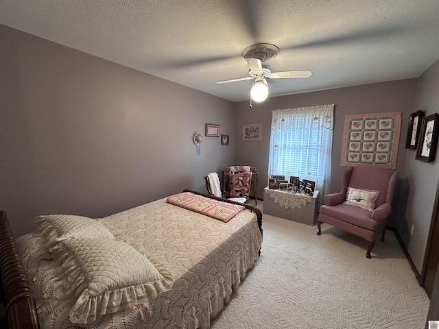 carpeted bedroom featuring ceiling fan and a textured ceiling