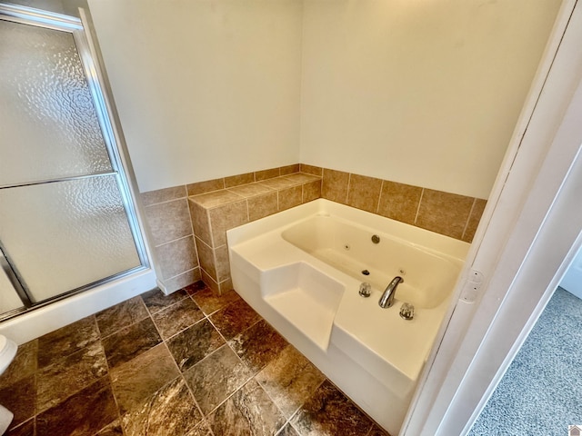 bathroom featuring tile walls and shower with separate bathtub