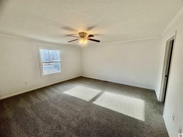 carpeted empty room featuring ceiling fan, ornamental molding, and a textured ceiling