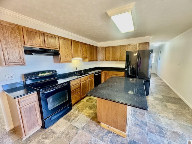 kitchen with ornamental molding, a textured ceiling, a kitchen island, and black appliances