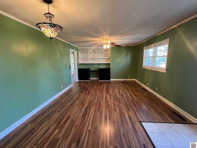 unfurnished living room with hardwood / wood-style flooring, crown molding, and ceiling fan