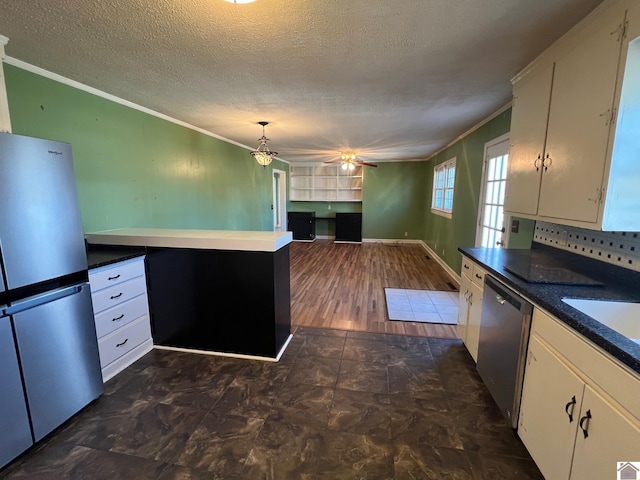 kitchen with stainless steel appliances, crown molding, hanging light fixtures, and white cabinets