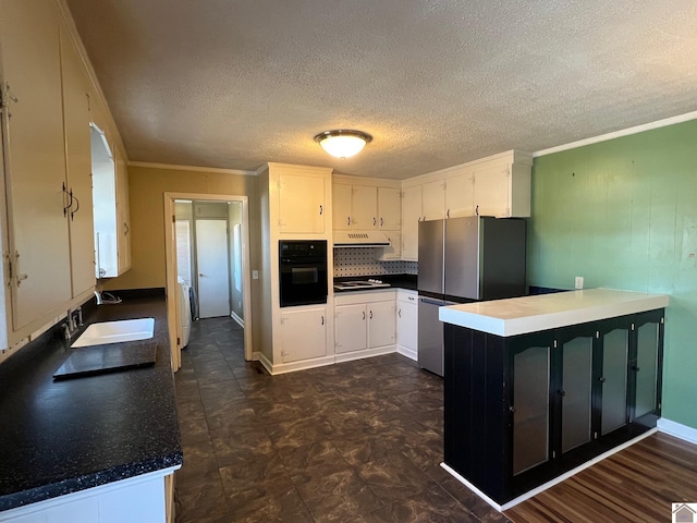 kitchen featuring stovetop, white cabinetry, stainless steel fridge, and black oven