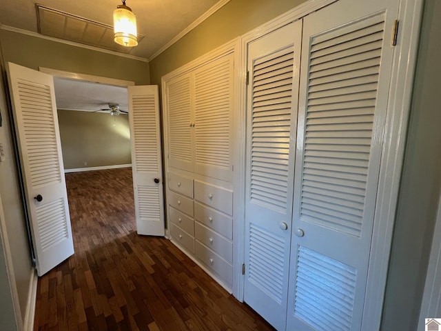 corridor with crown molding and dark wood-type flooring