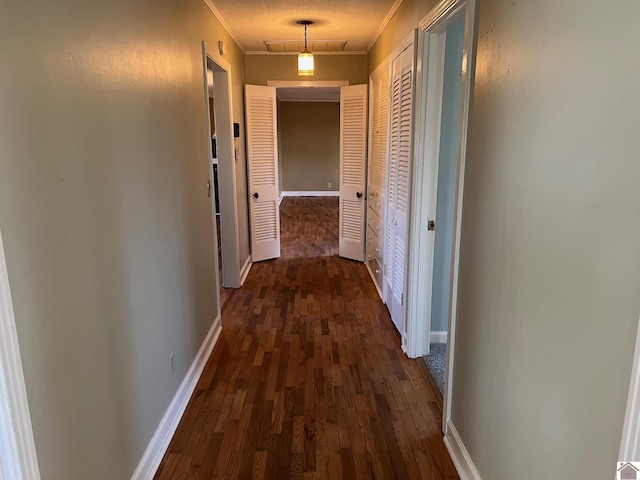 hall featuring crown molding and dark wood-type flooring