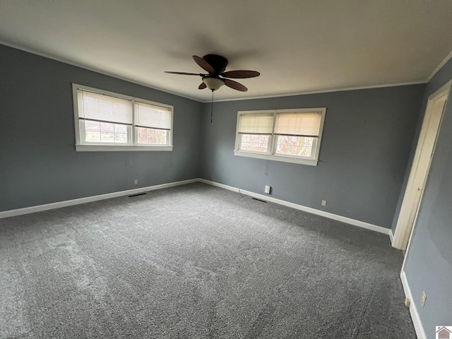 carpeted spare room featuring ceiling fan and ornamental molding