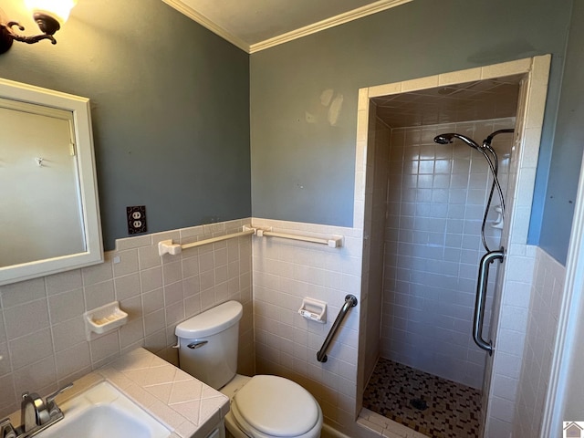 bathroom featuring toilet, a shower with shower door, sink, crown molding, and tile walls