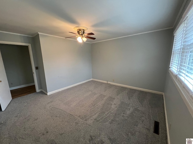 carpeted empty room featuring crown molding and ceiling fan