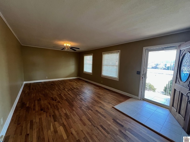 foyer entrance featuring ceiling fan, crown molding, a textured ceiling, and light hardwood / wood-style flooring