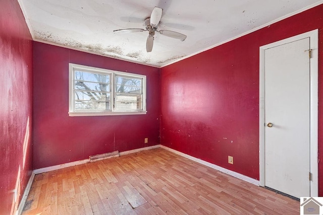 unfurnished room featuring ornamental molding, ceiling fan, and light hardwood / wood-style flooring