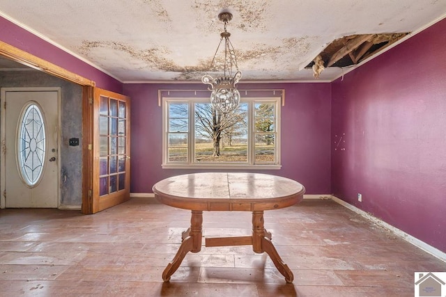 unfurnished dining area with ornamental molding, hardwood / wood-style floors, and an inviting chandelier