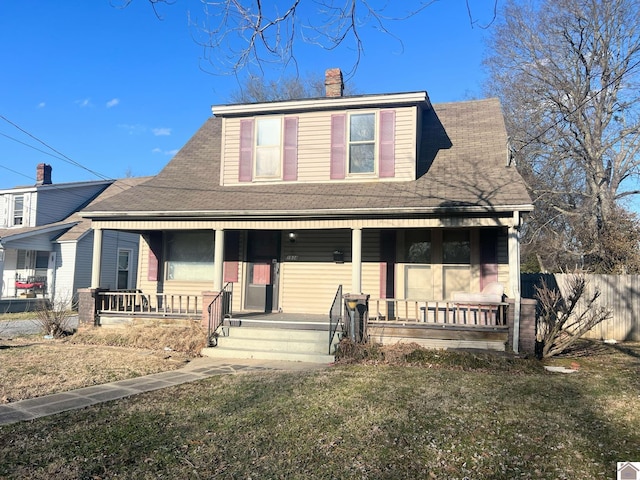 view of front of home with a porch and a front yard