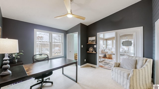 carpeted office space featuring vaulted ceiling and ceiling fan