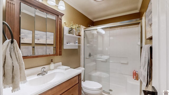 bathroom featuring a shower with door, ornamental molding, vanity, and toilet