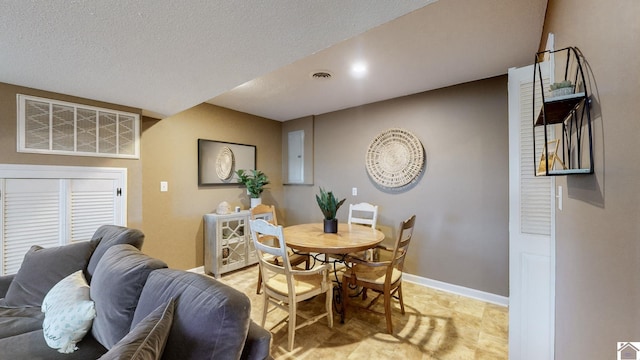 dining room featuring a textured ceiling