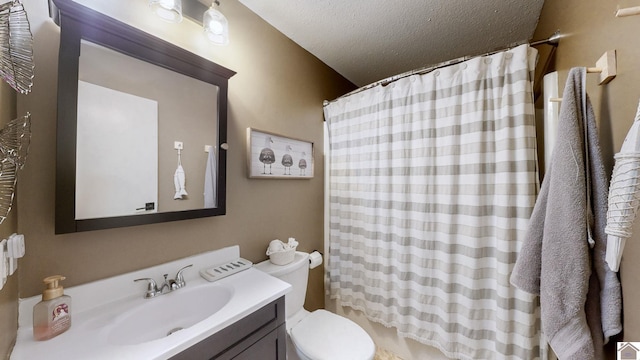 bathroom featuring a shower with curtain, vanity, toilet, and a textured ceiling