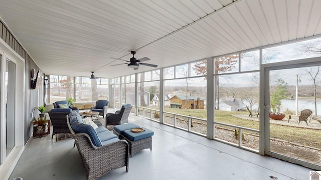 sunroom / solarium featuring ceiling fan