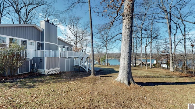 view of yard featuring a deck with water view