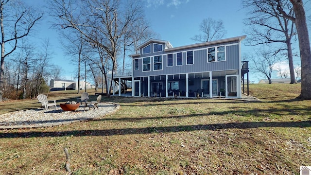 rear view of house with a sunroom and a lawn