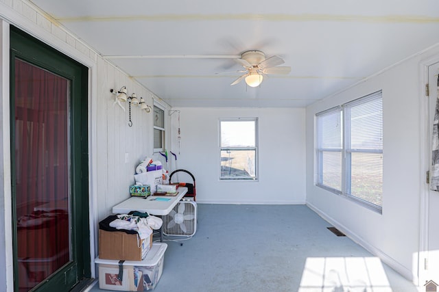 sunroom / solarium featuring ceiling fan and plenty of natural light