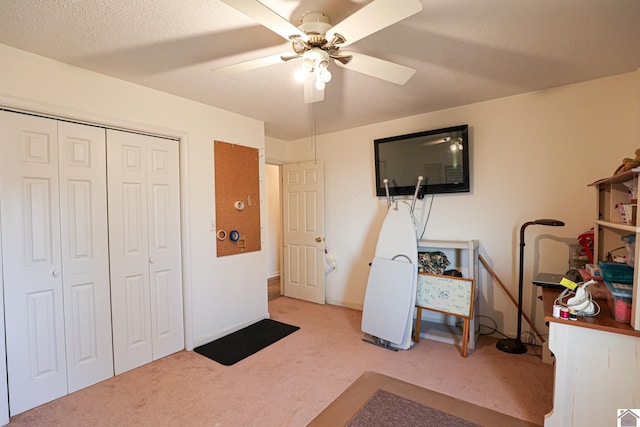 interior space with ceiling fan and a textured ceiling