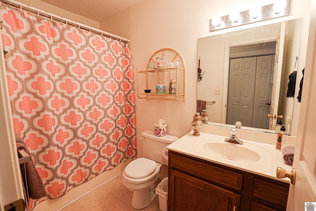 full bathroom featuring vanity, a textured ceiling, tile patterned floors, toilet, and shower / bath combo with shower curtain