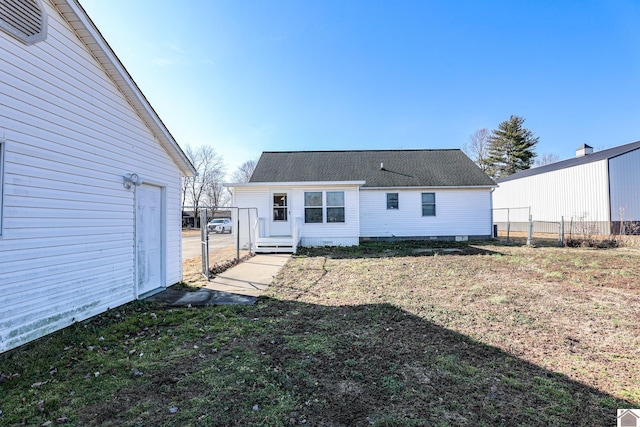 rear view of property with a yard