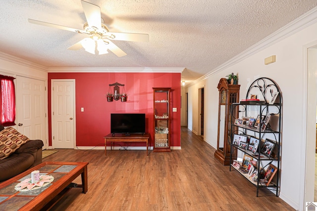 living room with hardwood / wood-style floors, crown molding, a textured ceiling, and ceiling fan