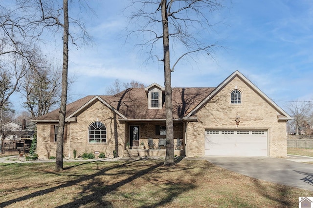 view of front of house featuring a garage, a porch, and a front lawn