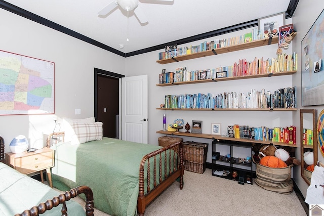 carpeted bedroom featuring crown molding and ceiling fan