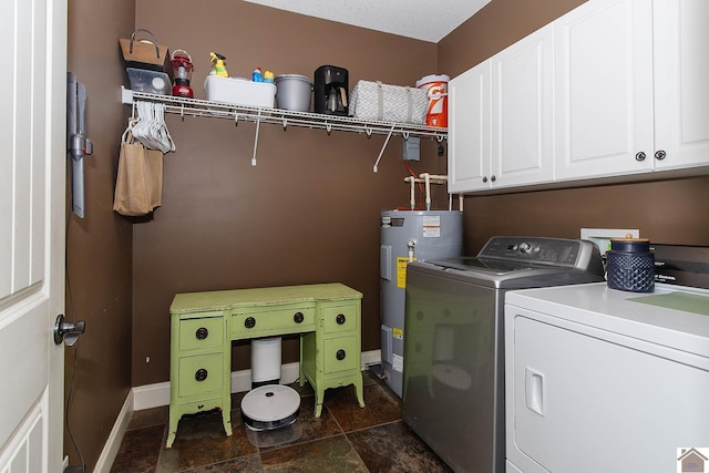 laundry area with cabinets, electric water heater, and washer and dryer