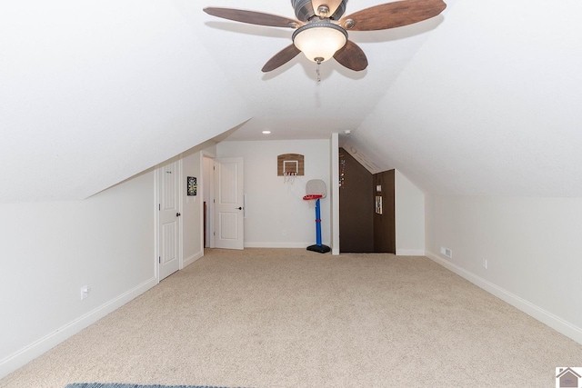 additional living space featuring lofted ceiling and carpet flooring