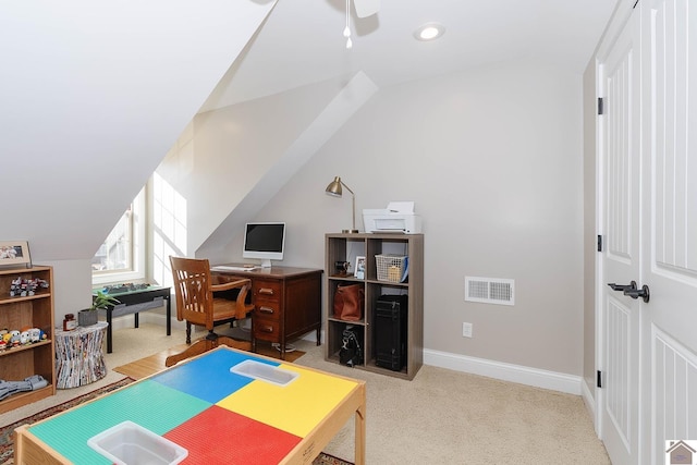 office with light carpet and vaulted ceiling